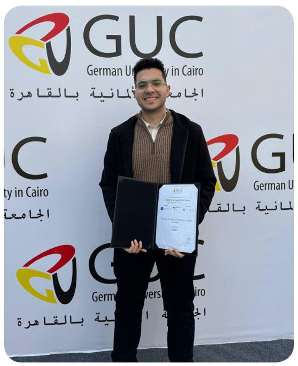 Mostafa receiving an award certificate at the German University in Cairo