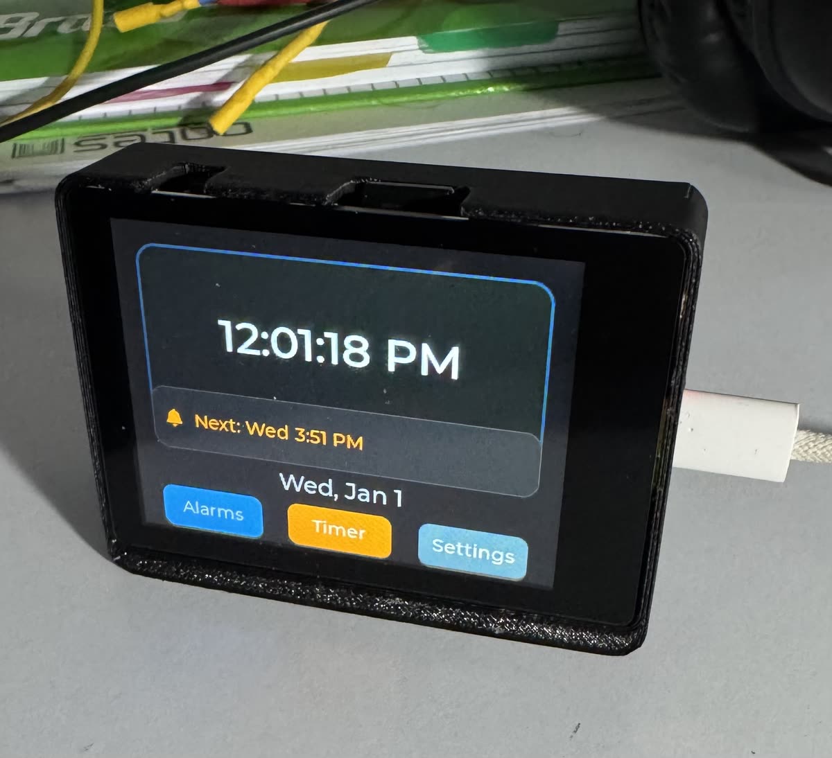 The clock's touch display showing the alarm interface