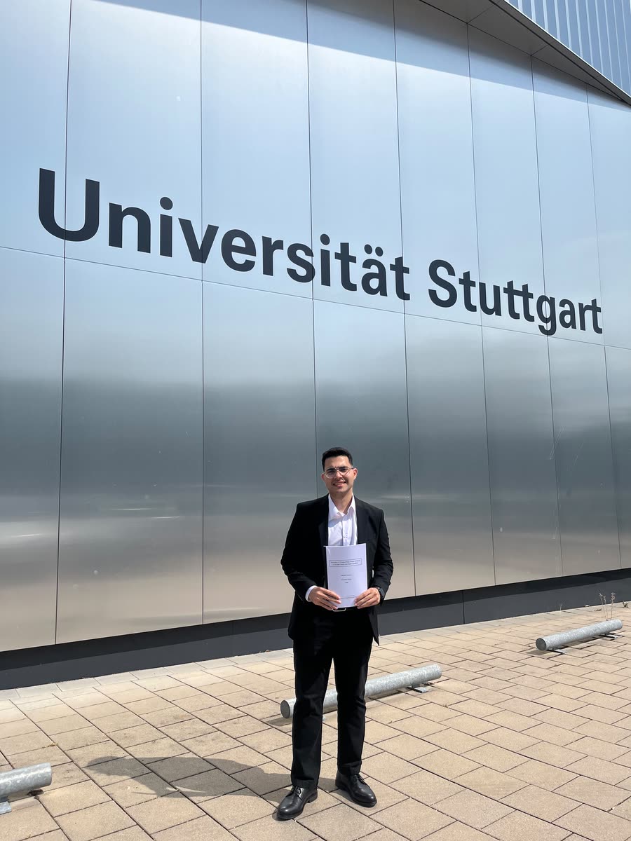 Mostafa Abdelaziz holding his bachelor thesis in front of the Universität Stuttgart building