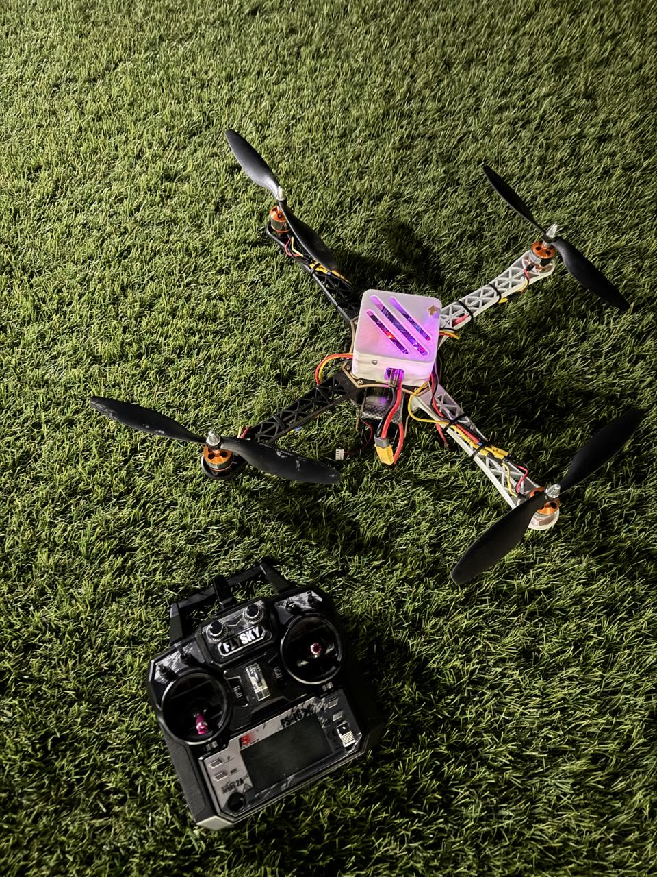The DroneX52 quadcopter next to its FlySky transmitter