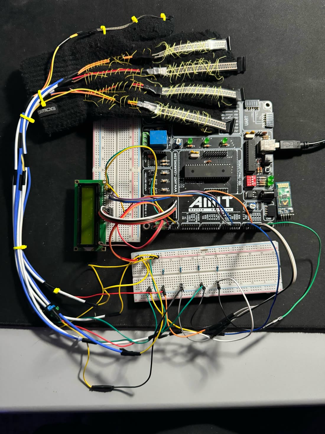 The glove with flex sensors wired to an ATmega32 development board